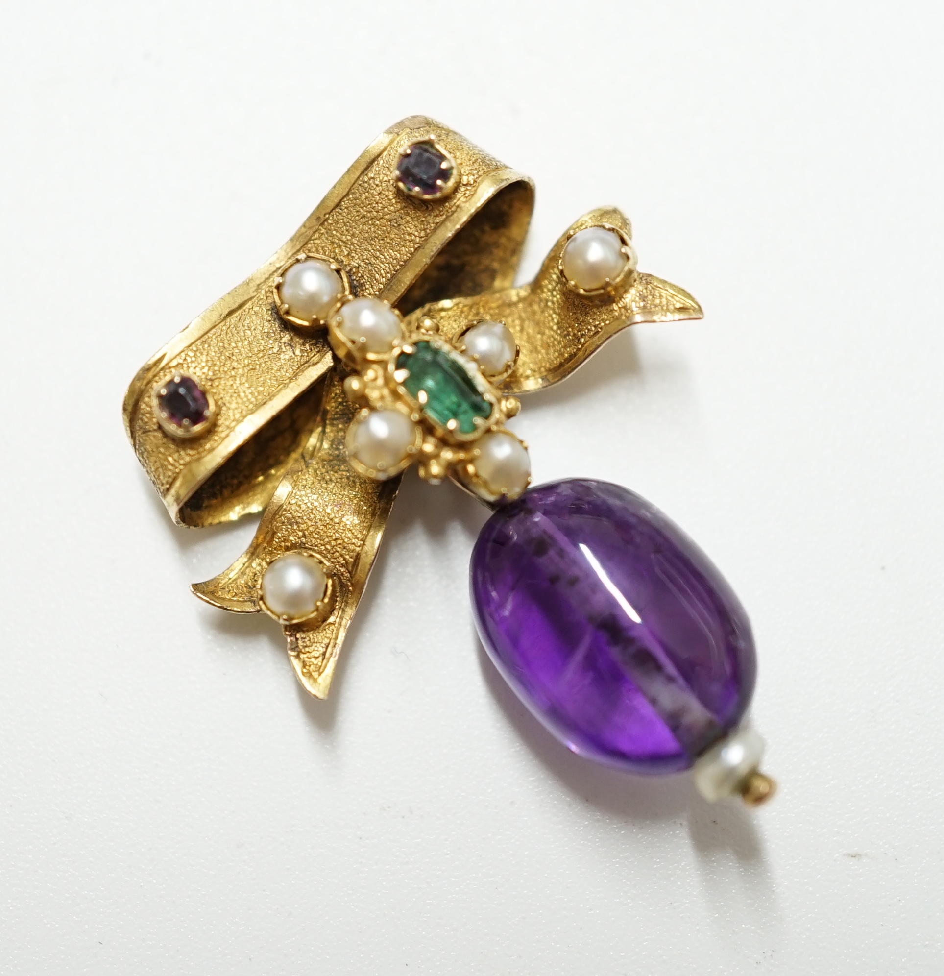 A late Victorian yellow metal, amethyst, emerald and seed pearl set drop brooch, 29mm, gross weight 3.2 grams. Condition - poor to fair